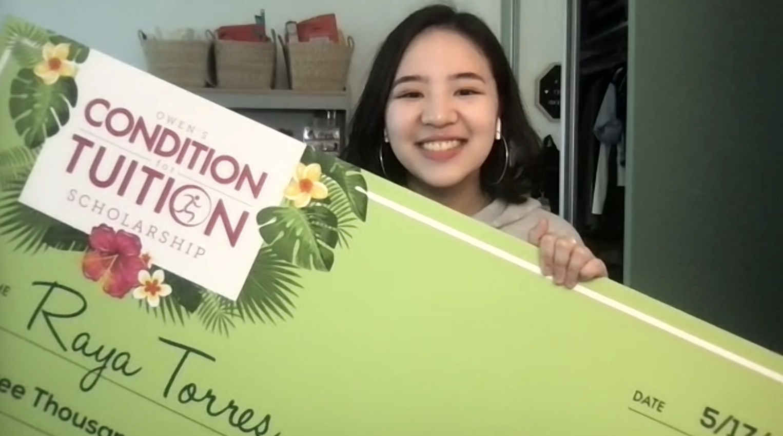 Torres in her dorm room with the Owen’s Condition For Tuition scholarship check. Photo credit Raya Torres.